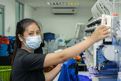 Portrait of young woman working at gourment factory