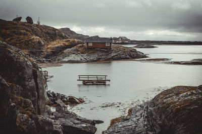 Scenic view of sea by buildings against sky