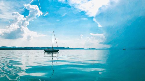 Sailboat sailing in sea against sky