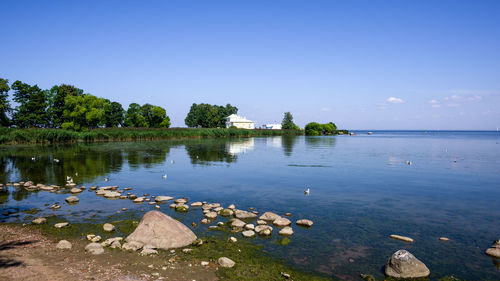 Scenic view of lake against clear blue sky. peterhof.