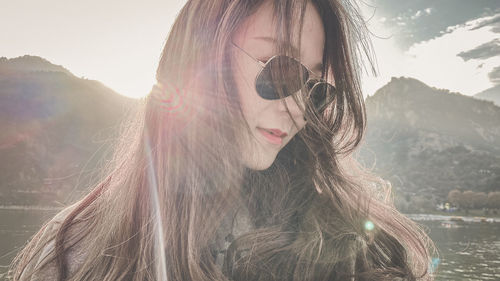 Portrait of beautiful young woman with arms outstretched