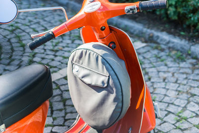 High angle view of orange motor scooter on street