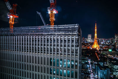 Illuminated modern buildings in city at night