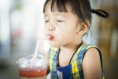 Close-up of girl drinking glass