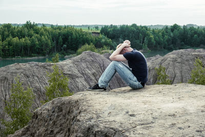 Man sitting on rock