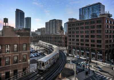 High angle view of railroad tracks amidst buildings in city