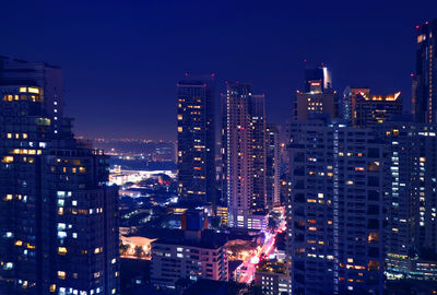 Fantastic aerial view of downtown bangkok with skyscrapers at night in deep blue color