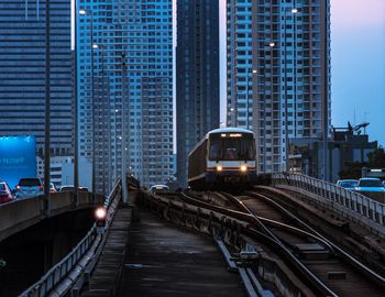 Railroad tracks amidst buildings in city
