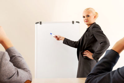 Young businesswoman with colleagues at board room