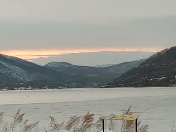 Scenic view of snowcapped mountains against sky during sunset