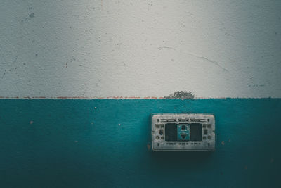 Close-up of telephone booth on wall