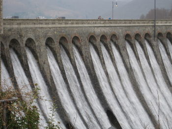View of dam against cloudy sky