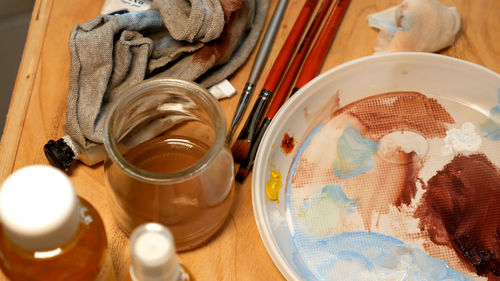 High angle view of art and craft equipment by honey in jar on table