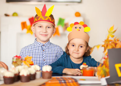 Smiling siblings wearing crown at hoe