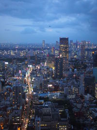 High angle view of illuminated city buildings against sky