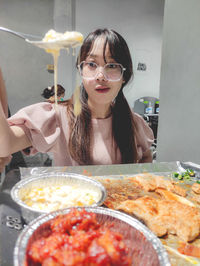 Portrait of young woman having food