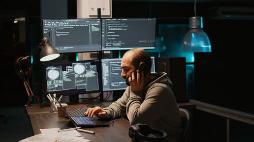 Rear view of man working in office