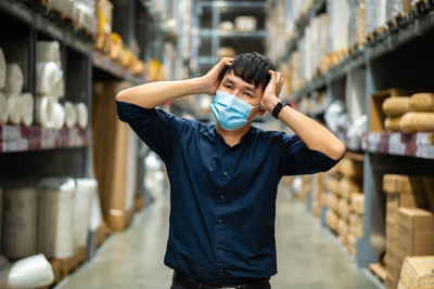 Man wearing mask standing in warehouse