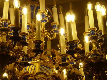 Low angle view of illuminated candles in building