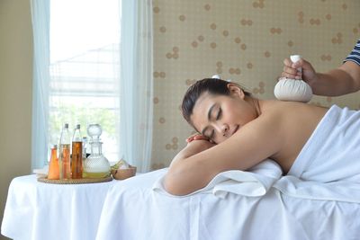 Young woman lying on bed at home