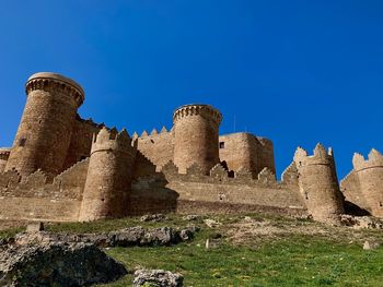 Low angle view of old ruins against blue sky