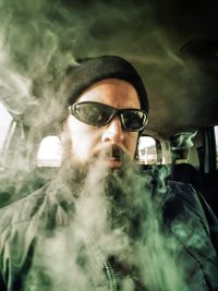 Young man smoking cigarette