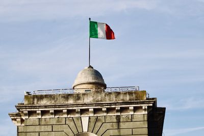 Low angle view of flag building against sky