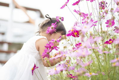 Rear view of bride holding flowers