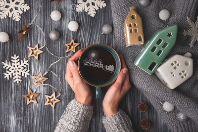 High angle view of woman holding food on table