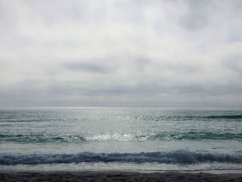 Scenic view of sea against cloudy sky