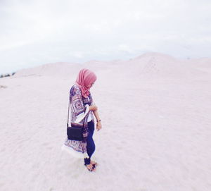 Full length of woman standing on mountain