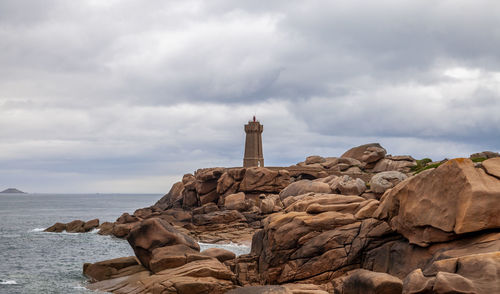 Panoramic view of the famous ploumanach lighthouse among the giant pink boulders in brittany