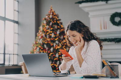 Young woman using laptop at home