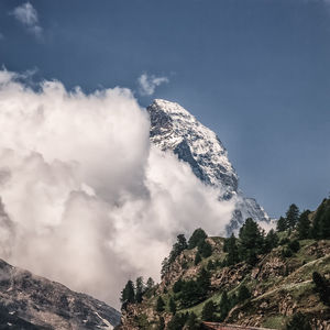 Low angle view of snowcapped mountains against sky