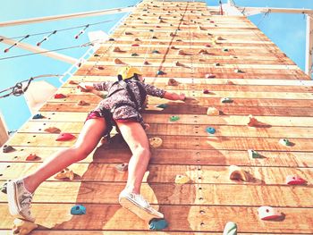 Low angle view of woman on climbing wall