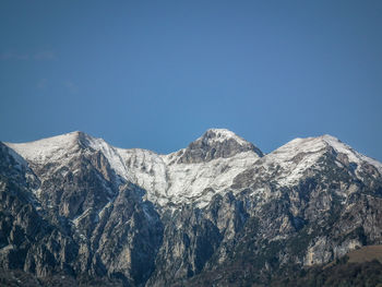 Scenic view of mountains against clear blue sky