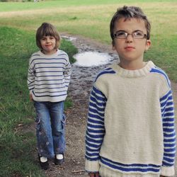 Portrait of boy and girl standing outdoors