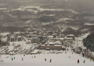 People skiing on snow covered field