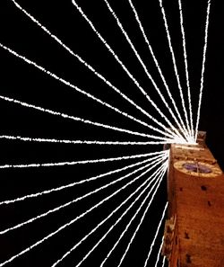 Close-up of illuminated lights against black background