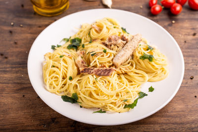 Spaghetti with mackerel served on white plate. meal rich in omega 3