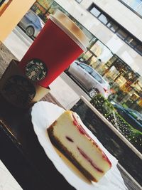 Tilt image of dessert with drink on table at outdoor cafe