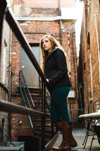 Young woman standing in balcony