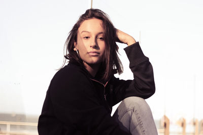 Portrait of beautiful young woman against white background