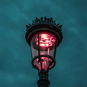 Low angle view of illuminated street light against sky