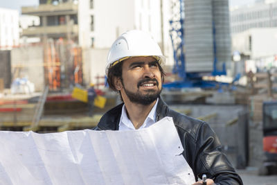 Portrait of smiling man standing against building