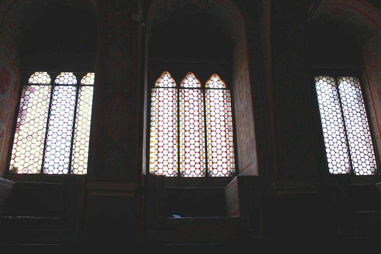 indoors, window, glass - material, architecture, built structure, stained glass, interior, transparent, religion, church, place of worship, curtain, design, pattern, spirituality, arch, home interior, sunlight, no people