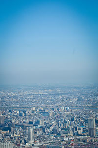 High angle view of townscape against clear blue sky