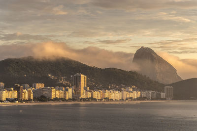 City at waterfront during sunset