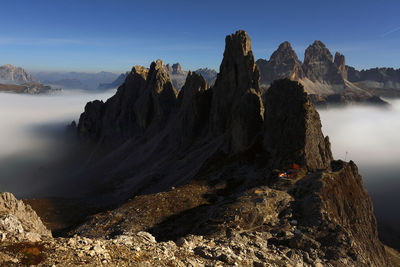 Scenic view of mountains against blue sky