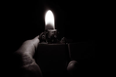 Close-up of hand holding candle